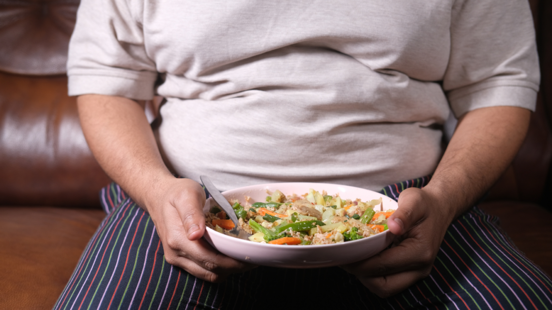 Obese person with plate of food