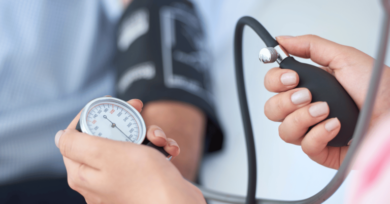 Doctor manually measuring blood pressure of patient